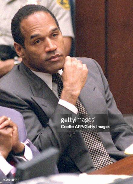 Former American football star and actor O.J. Simpson listens to testimony during his double murder trial in Los Angeles, March 16, 1995. Simpson is...