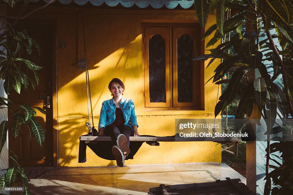 Woman sitting near the house