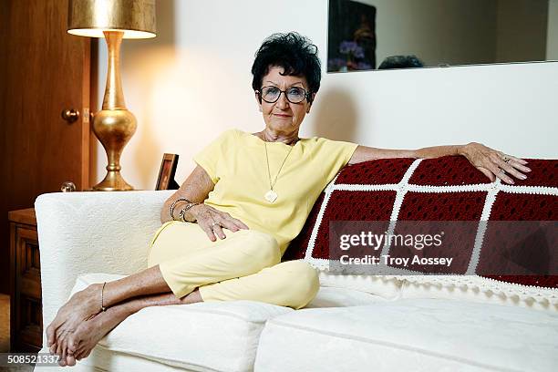 senior woman on sofa relaxed and barefoot - tempe arizona stock pictures, royalty-free photos & images