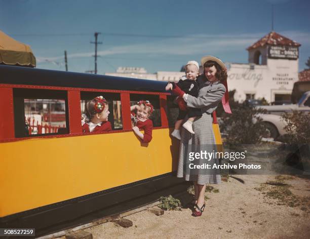 American actress, singer and songwriter Dale Evans watches some children on a miniature train, circa 1947. She was the second wife of actor Roy...