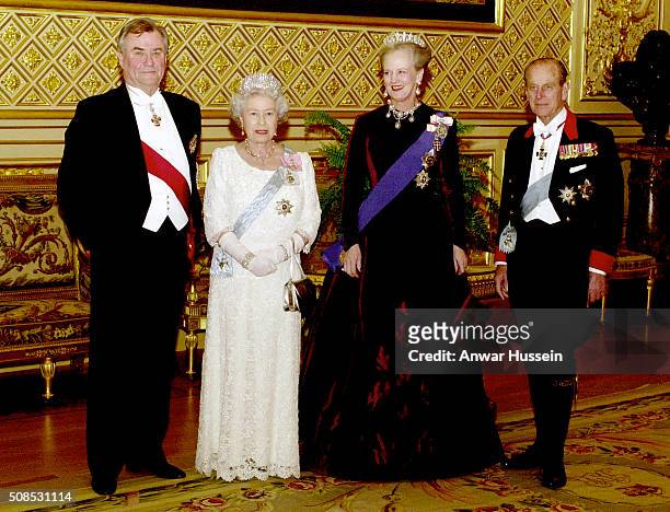 Queen Elizabeth II and Queen Margrethe of Denmark, with Prince Philip, Duke of Edinburgh and Prince Henrik pose before the state banquet at St...