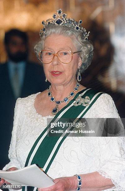 Queen Elizabeth II, wearing a sapphire and diamond tiara which she had made to match the cluster necklace and earrings which were a wedding present...