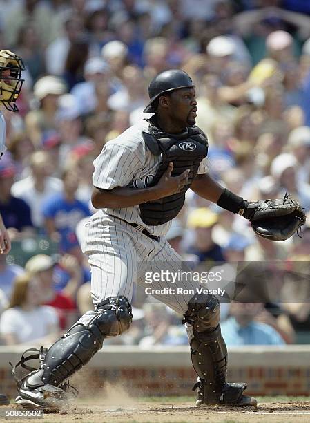 Catcher Charles Johnson of the Colorado Rockies stands during the game against the Chicago Cubs at Wrigley Field on May 9, 2004 in Chicago, Illinois....