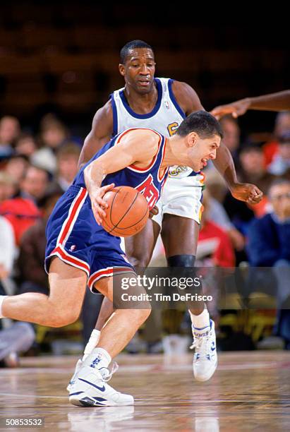 Drazen Petrovic of the New Jersey Nets drives on Walter Davis of the Denver Nuggets during a 1991-92 season game at McNichols Arena in Denver,...