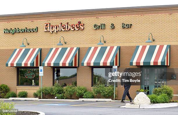 Customer walks towards an entrance to an Applebee's restaurant May 18, 2004 in Palatine, Illinois. Applebee's has introduced new Weight Watchers...