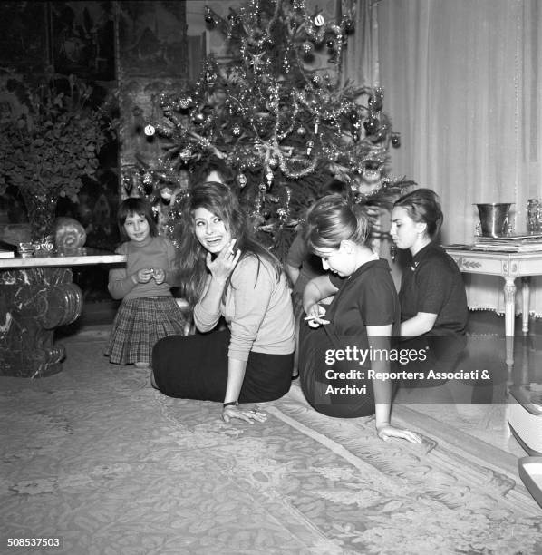 Italian actress Sophia Loren celebrates Christmas in her house of Rome with her sister Maria Scicolone and other relatives, Rome, 1950s.