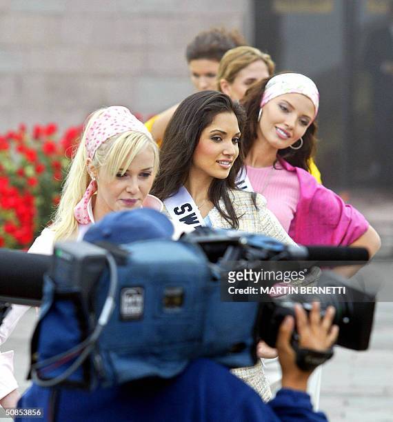 Miss Universe candidates , Miss Canada Venessa Fisher, Miss Switzerland Bianca Sissing and Miss Ukraine Oleksandra Nikolayenko, pose for TV cameramen...