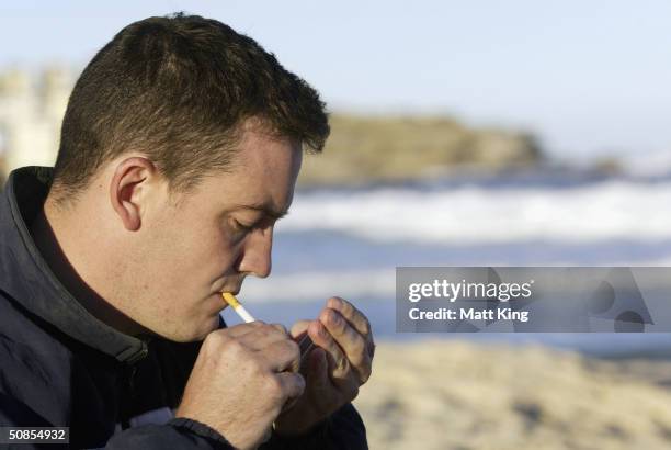 Smoker lights a cigarette on Bondi Beach May 19, 2004 in Sydney, Australia. Waverley Council has passed a motion to investigate the legalities and...