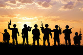silhouette of  Soldiers team with sunrise background