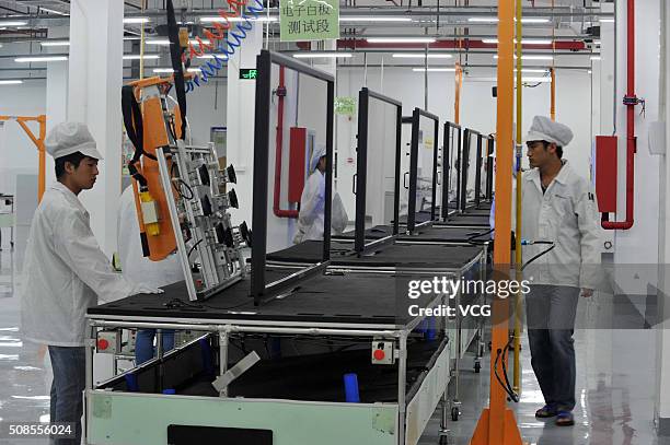 Workers on the production line at Foxconn demonstration plant on July 10, 2014 in Guiyang, Guizhou province of China. CEO of Foxconn Guo Taiming...