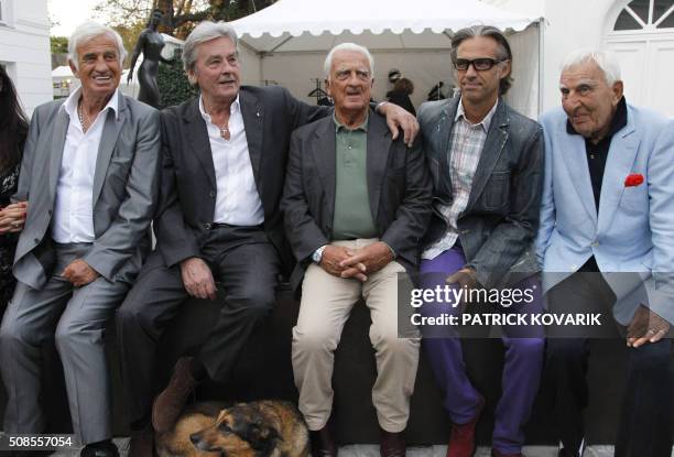 French actor Jean-Paul Belmondo poses beside French actor Alain Delon, his brother Alain Belmondo, his son Paul Belmondo and French actor Charles...