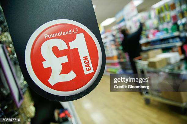 One pound sterling sign hangs near shelves at a Poundland Group Plc store in Leigh, U.K., on Thursday, Feb. 4, 2016. U.K. Like for like sales at...