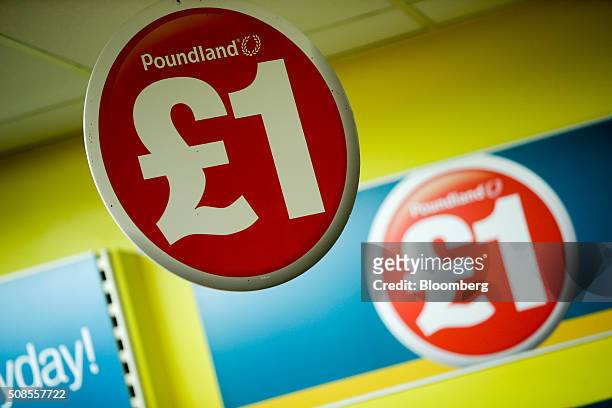 One pound sterling sign hangs from the ceiling at a Poundland Group Plc store in Leigh, U.K., on Thursday, Feb. 4, 2016. U.K. Like for like sales at...
