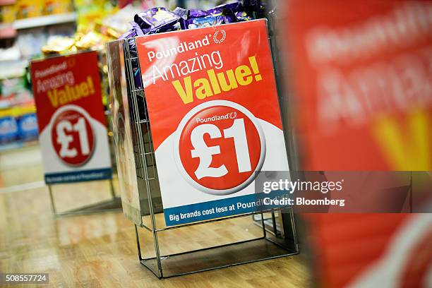 Chocolate snacks sit in a wire basket bin with a one pound sterling sign attached at Poundland Group Plc store in Leigh, U.K., on Thursday, Feb. 4,...