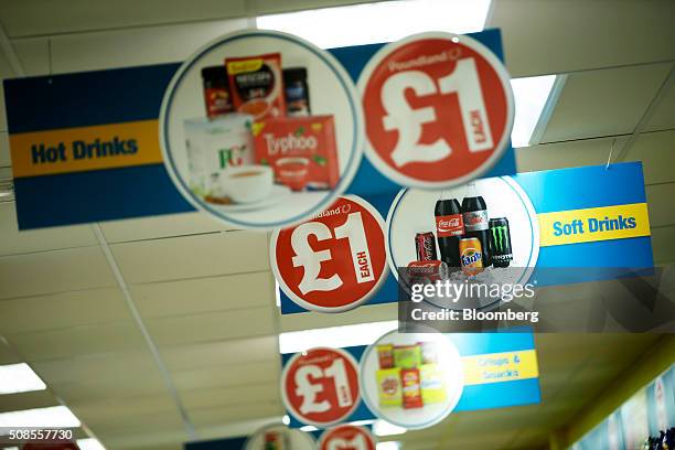 One pound sterling signs hang from the ceiling at a Poundland Group Plc store in Leigh, U.K., on Thursday, Feb. 4, 2016. U.K. Like for like sales at...