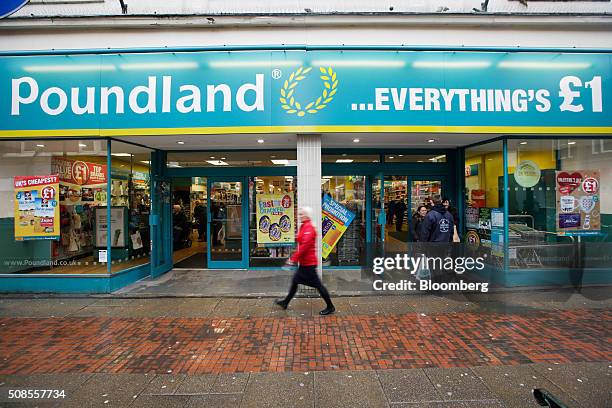 Pedestrians pass in front of a Poundland Group Plc store in Leigh, U.K., on Thursday, Feb. 4, 2016. U.K. Like for like sales at mid-market retailers...