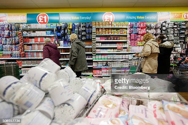 Customers browse toiletries for sale at a Poundland Group Plc store in Leigh, U.K., on Thursday, Feb. 4, 2016. U.K. Like for like sales at mid-market...