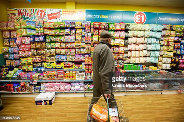 Customer walks through a Poundland Group Plc store in Leigh, U.K., on Thursday, Feb. 4, 2016. U.K. Like for like sales at mid-market retailers rose...