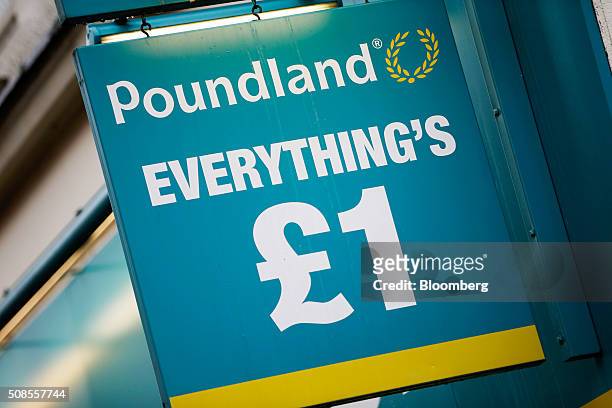 One pound sterling sign hangs outside a Poundland Group Plc store in Leigh, U.K., on Thursday, Feb. 4, 2016. U.K. Like for like sales at mid-market...