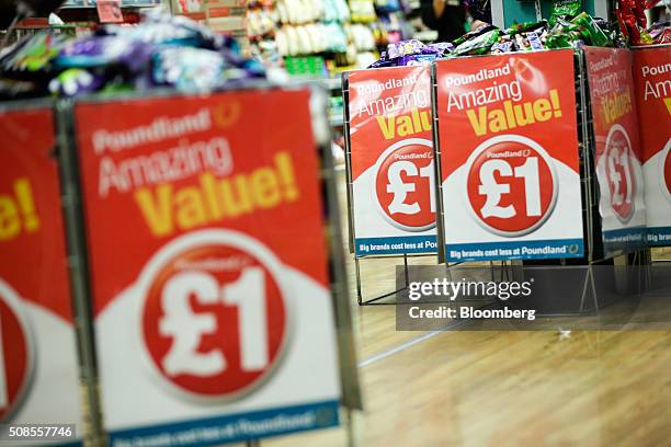 Chocolate snacks sit in wire basket bins with a one pound sterling sign attached at Poundland Group Plc store in Leigh, U.K., on Thursday, Feb. 4,...