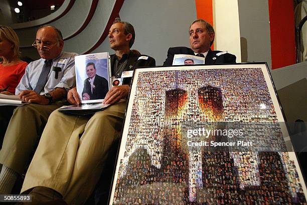 As former New York City Mayor Rudy Giuliani testifies, relatives of Mark Petrocelli, who was killed on September 11, hold up pictures at a public...