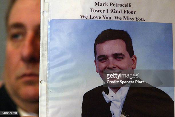 As former New York City Mayor Rudolph Giuliani testifies, Al Petrocelli holds up a picture of his son Mark, who was killed on September 11, at a...