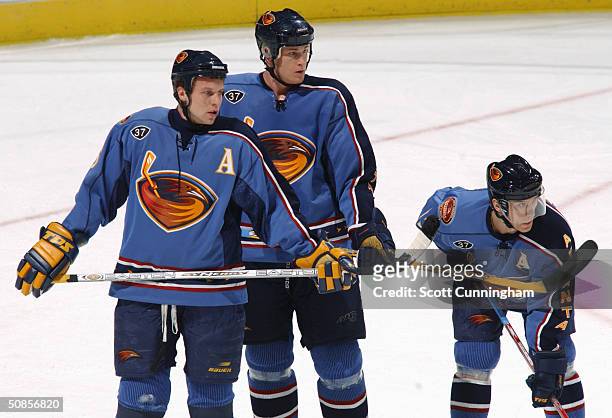 Right wing Dany Heatley of the Atlanta Thrashers stands next to his teammates defenseman Andy Sutton and left wing Vyacheslav Kozlov during the game...