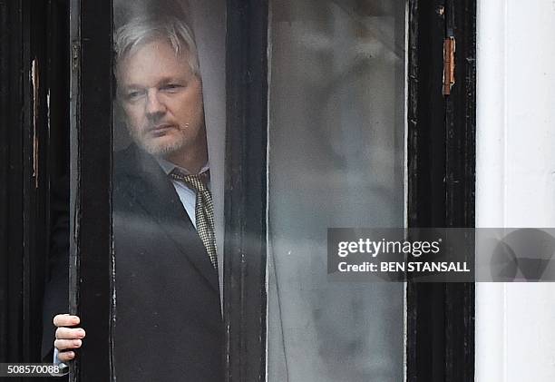 WikiLeaks founder Julian Assange comes out on the balcony of the Ecuadorian embassy to address the media in central London on February 5, 2016....