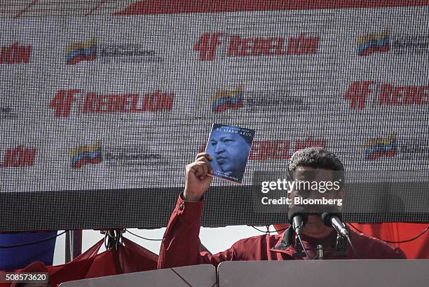 Nicolas Maduro, Venezuela's president, holds a copy of the El Libro Azul, or The Blue Book, written by former Venezuelan President Hugo Chavez, while...