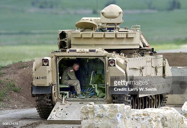 Soldier from the 1st Battalion, 41st Infantry, 3rd Brigade, 1st Armored Division sits in the back of a Bradley Fighting Vehicle during training...
