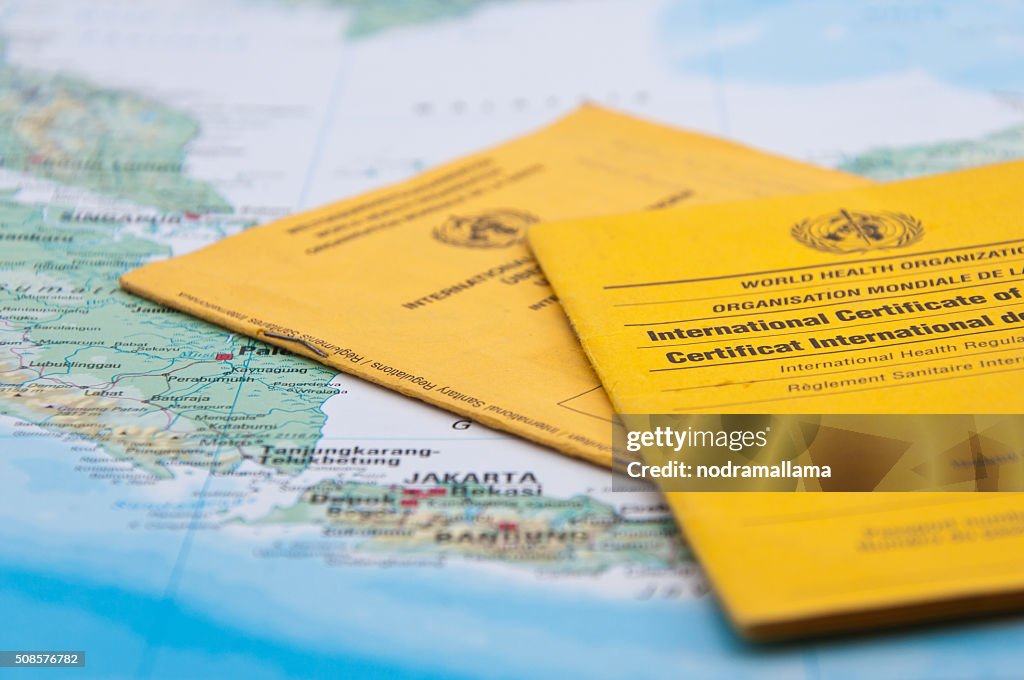 Close Up of Vaccination Certificate and world map.