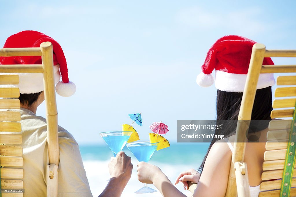 Couple Celebrating Christmas Vacation on Beach with Tropical Drinks Horizontal