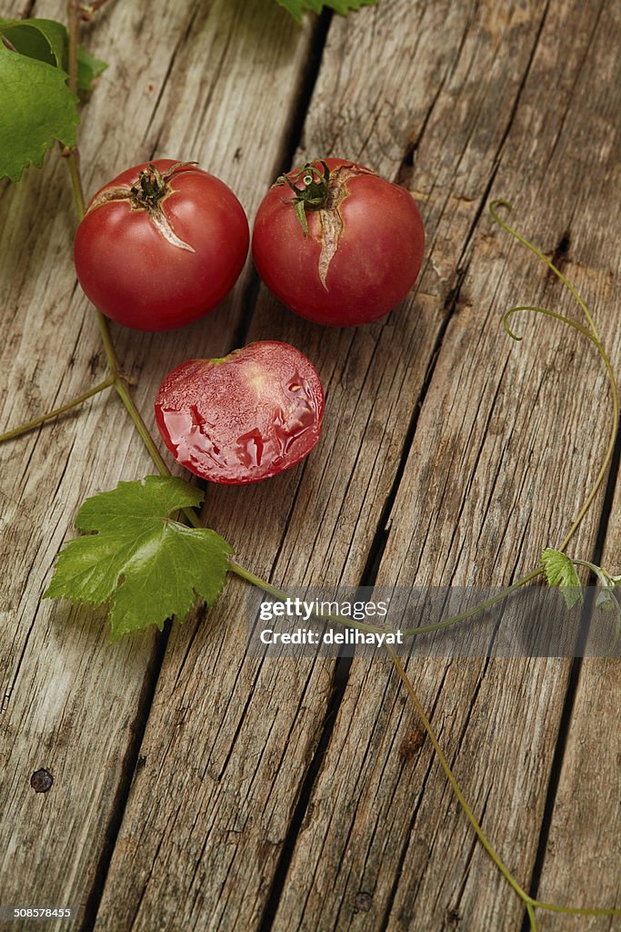 Fresh ripe  tomatoes on wooden background