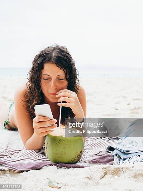 junge frau, surfen im internet in vacations - pretty girls in swimsuits stock-fotos und bilder