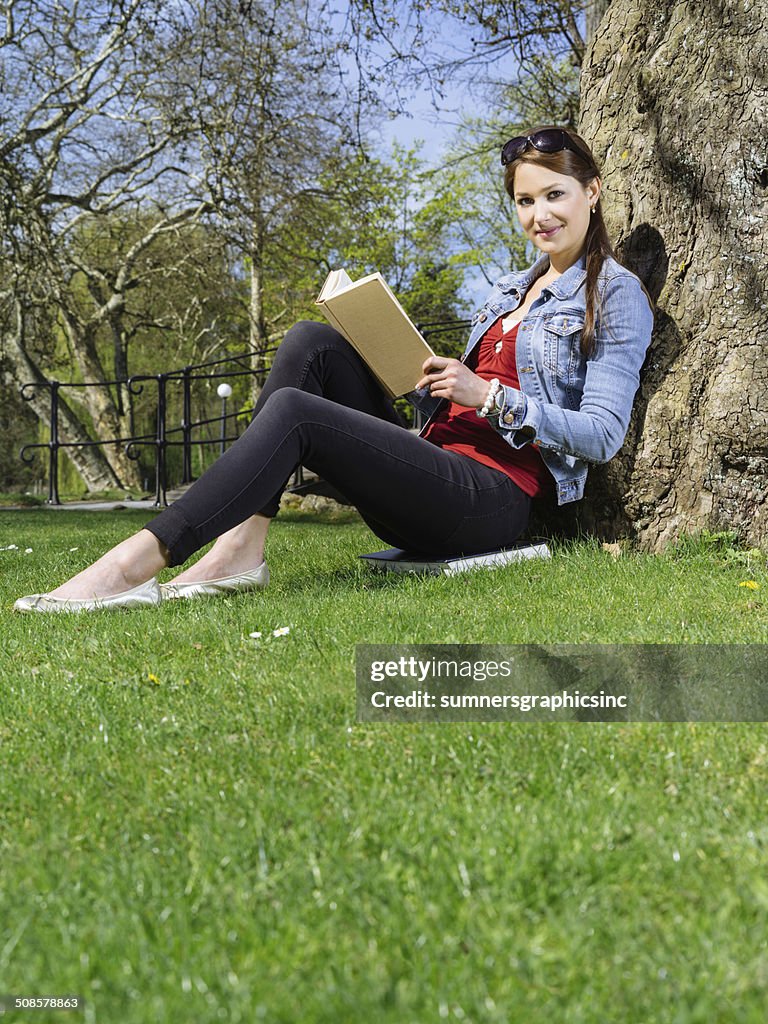 Young woman reading in the park