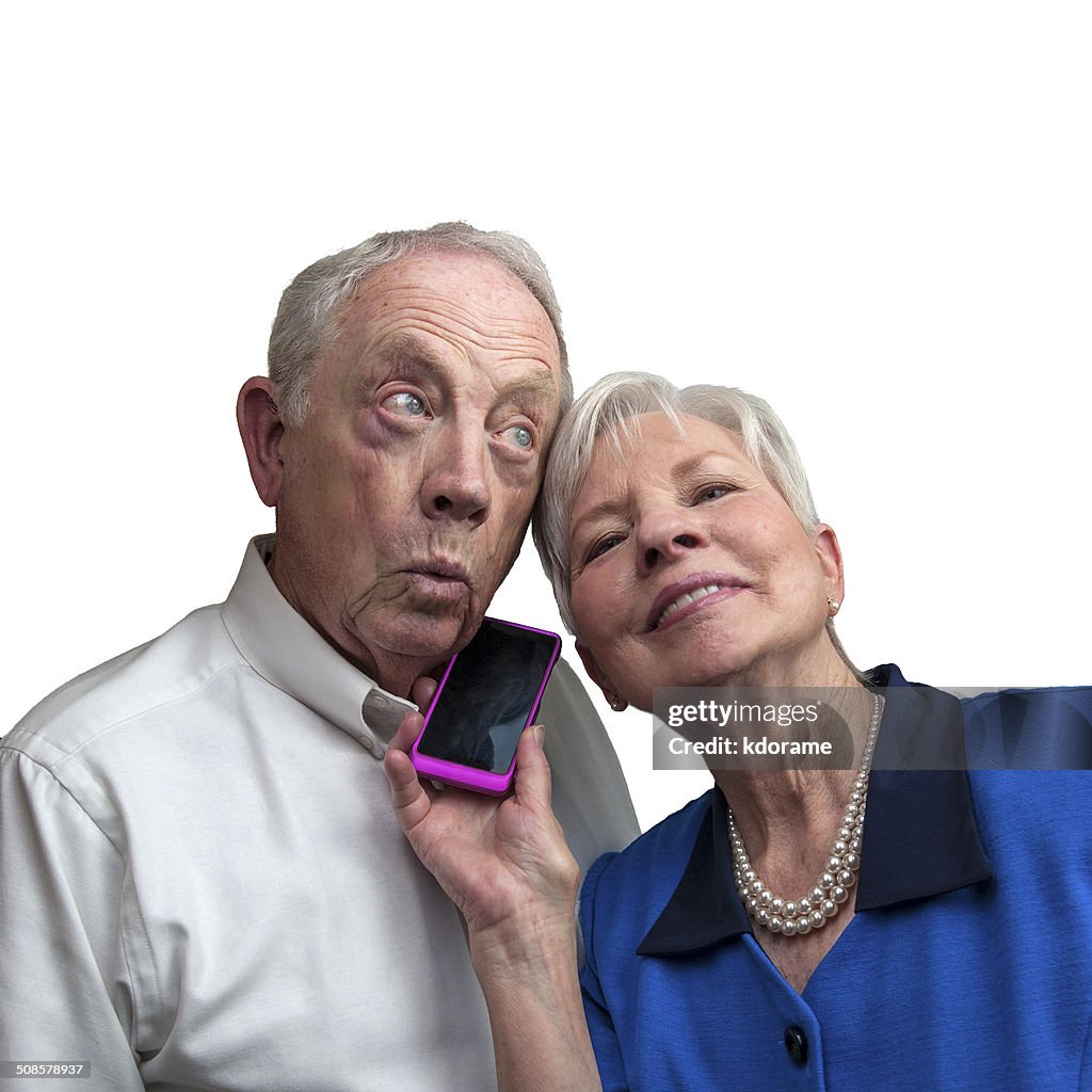 Mature Couple Listening Together on Cell Phone