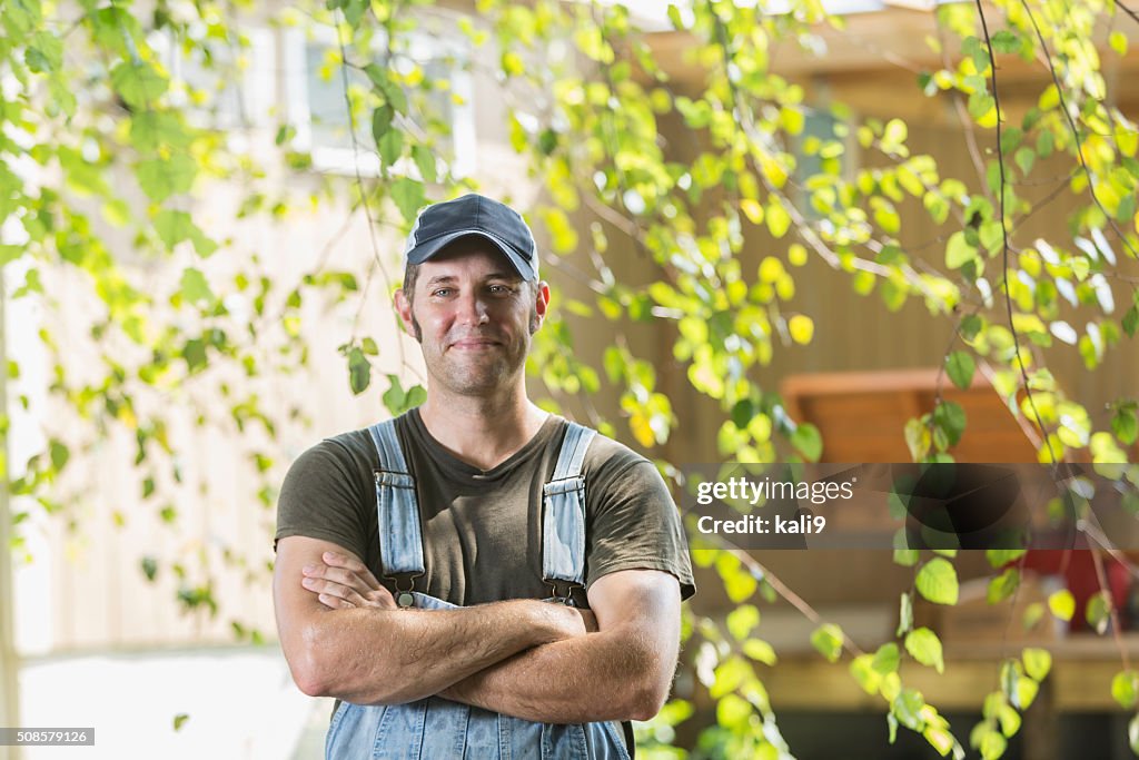 Portrait of farmer with arms folded, smiling