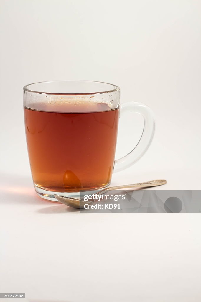 Cup of black tea on a white background