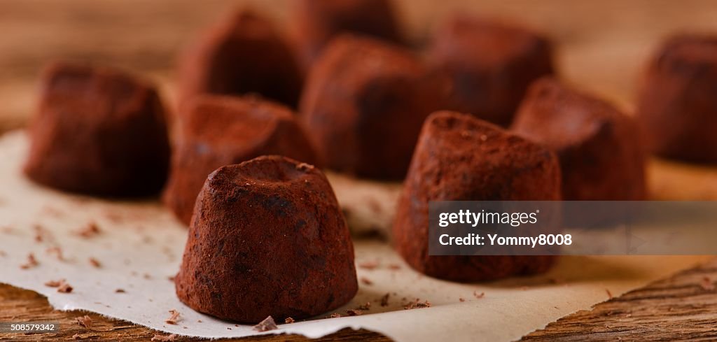 Several chocolate truffles on piece of paper