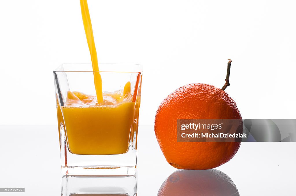 Orange juice pouring into glass