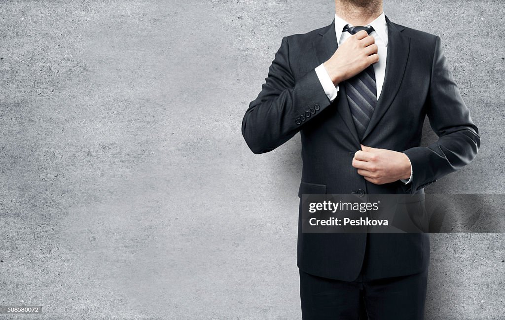 Businessman straightens his tie