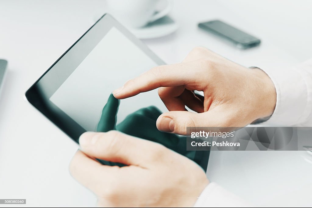 Hand touching digital tablet