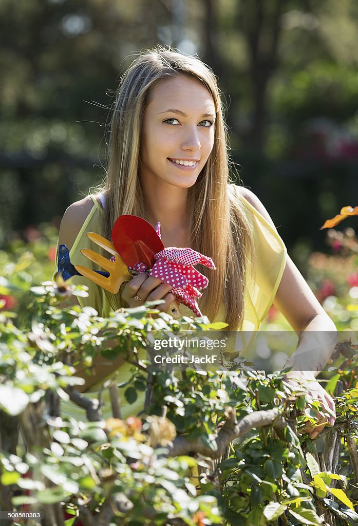 Happy woman in yard gardening