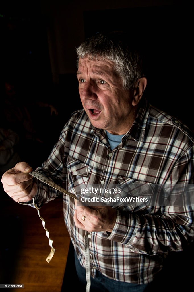 Mature man measuring waistline