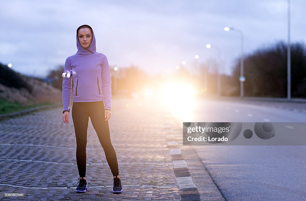 Female jogger at winter evening outdoors