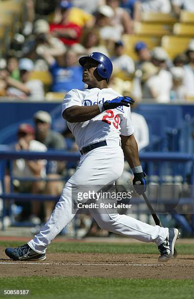 Infielder Adrian Beltre of the Los Angeles Dodgers swings at a Montreal Expos pitch during the game at Dodger Stadium on May 2, 2004 in Los Angeles,...