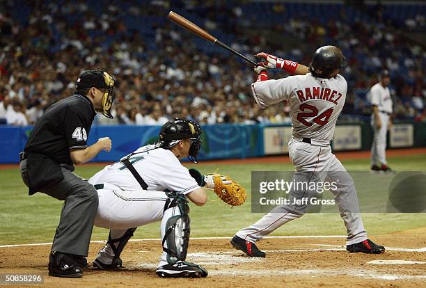 Manny Ramirez of the Boston Red Sox hits a two-run home run in the third inning against the Tampa Bay Devil Rays on May 19, 2004 at Tropicana Field...