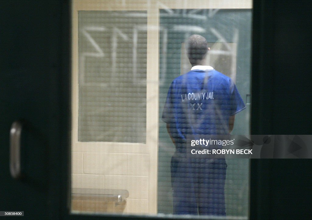 A prisoner waits in a holding cell in th