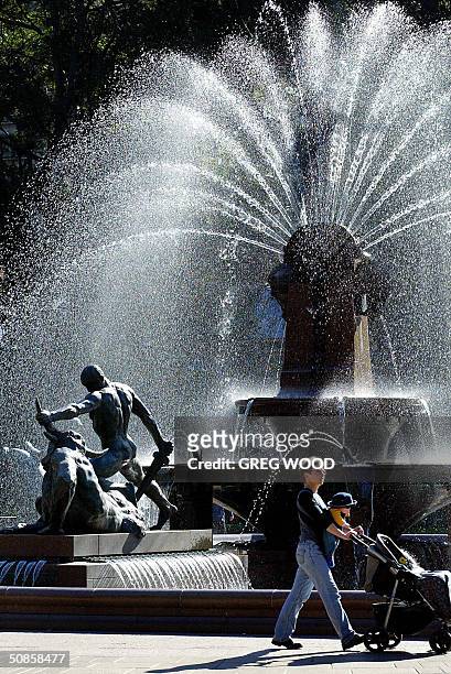 Woman walks past the Archibald Fountain in Sydney's Hyde Park, 20 May 2004. New figures released 19 May by the Australian Bureau of Statistics, show...