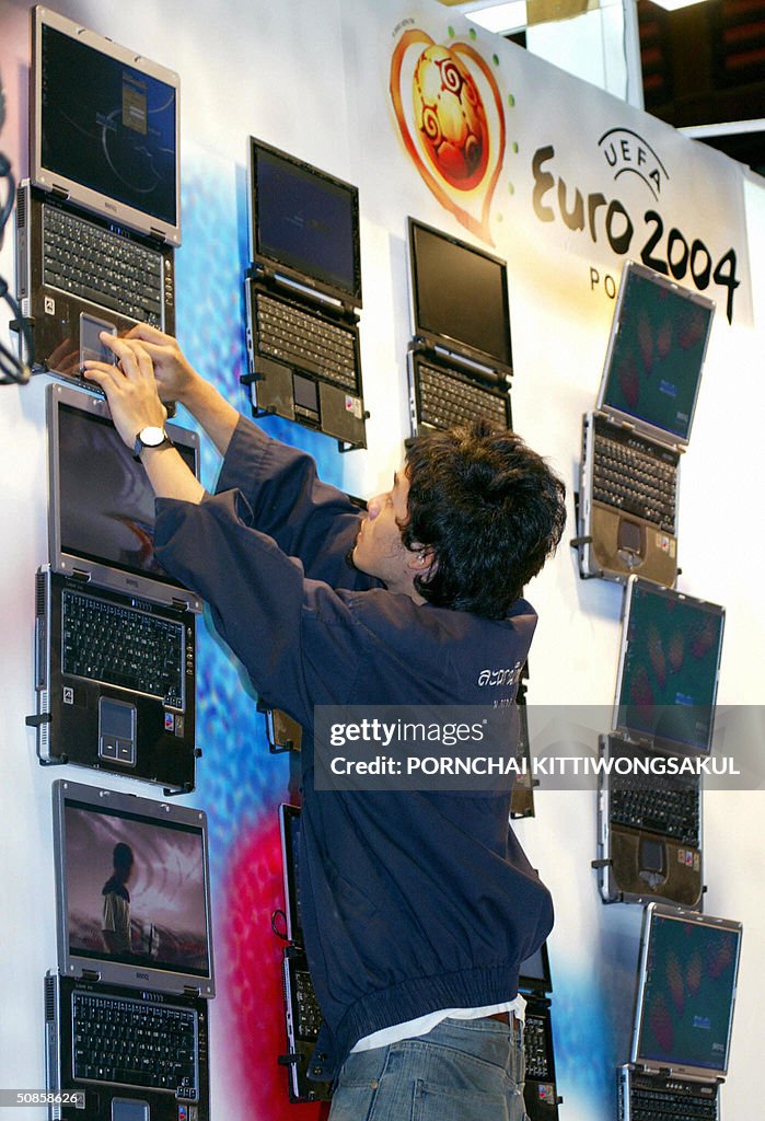 A Thai worker adjusts nootbook computers